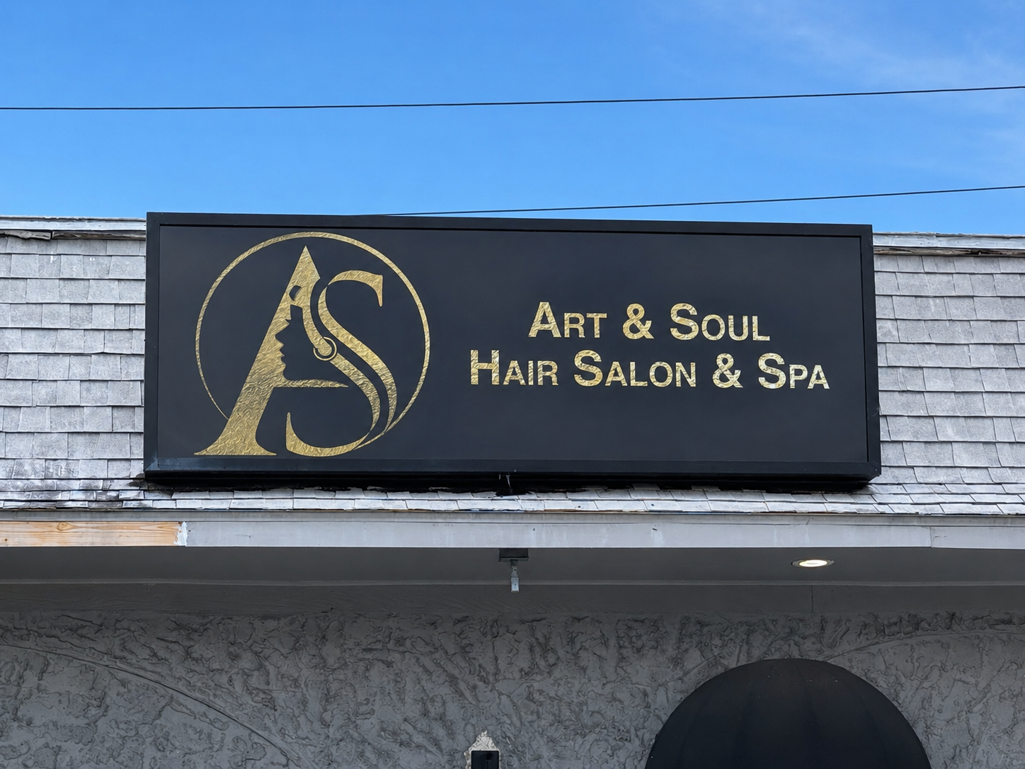 Exterior storefront sign reading Art & Soul Hair Salon & Spa
