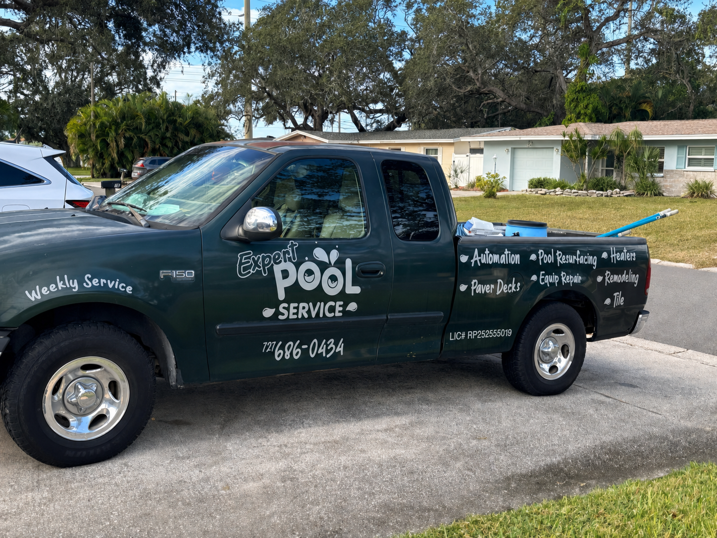 Expert Pool Service commercial vehicle lettering with listed pool services and phone number 727 686-0434