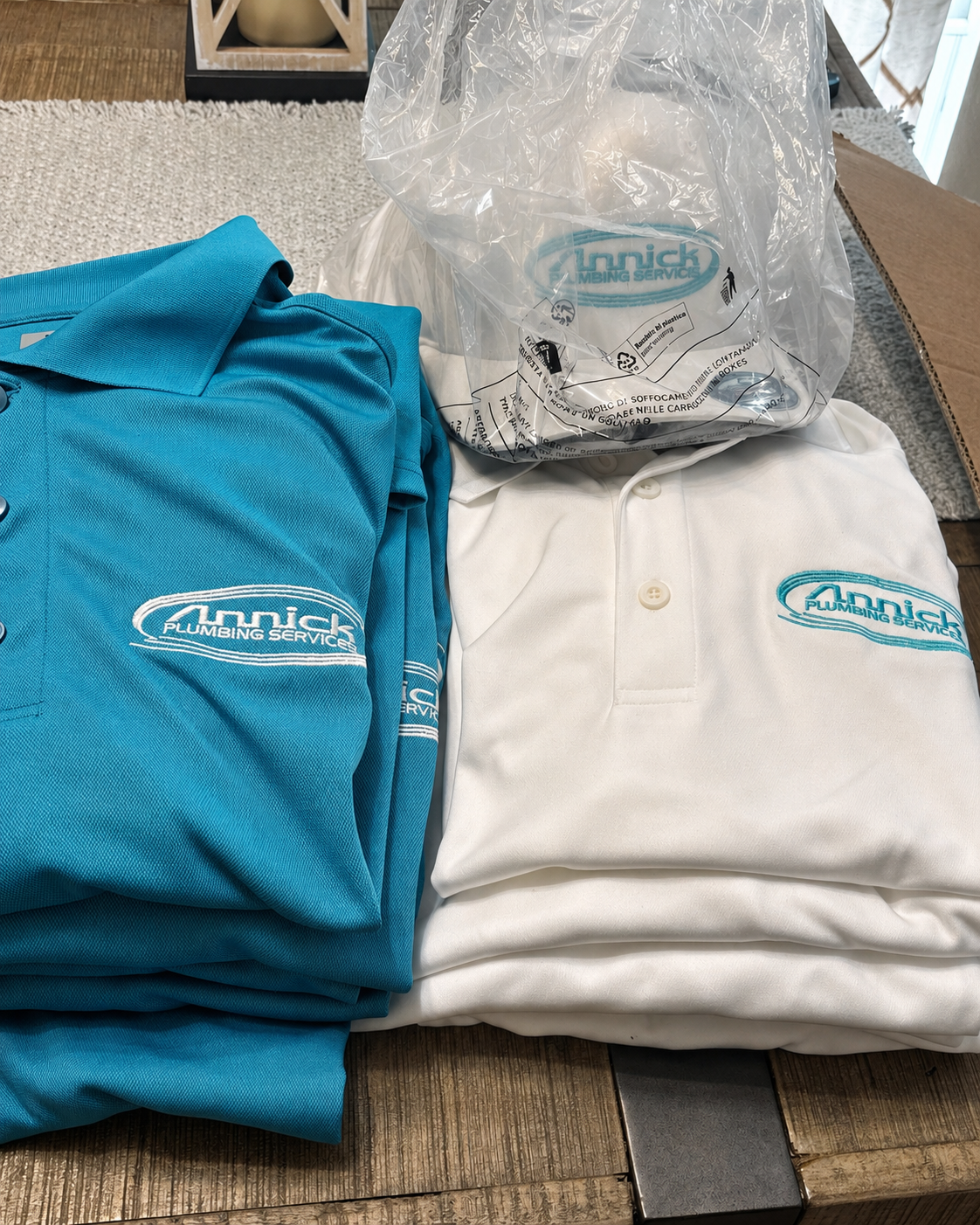 Teal and white embroidered plumbing polos
